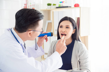 口腔诊疗美丽的亚洲女人张开嘴做口腔检查的医生照片