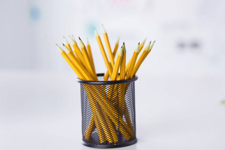 金属网格容器中的石墨铅笔。概念