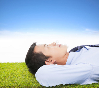 躺在草地上的年轻商人