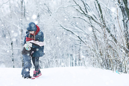 两个小女孩在冬季公园玩雪。 童年友谊家庭的概念