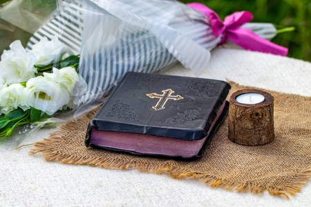 圣经和蜡烛在麻布餐巾上。