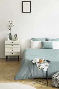 s bedroom interior with white walls, parquet floor, pale sage gr