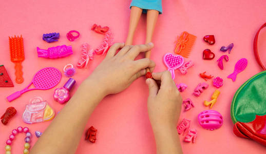 s cosmetics and jewelry Flat lay toys on pink background. View f