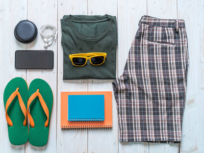 s casual outfits of traveler, summer holiday on wood background