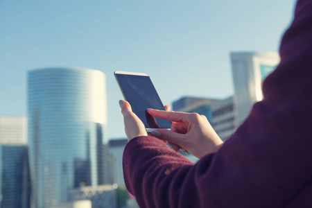 s hand while using touch screen on smartphone in Paris, France, 