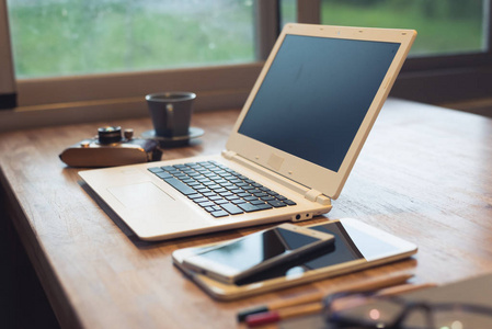 眼镜和笔记本电脑放在桌子上，没有人，在家工作的概念