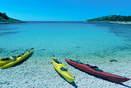 黄色和红色的海上独木舟在海滩上，蓝天和海洋背景在科纳提岛海湾国家公园在克罗地亚亚的亚得里亚海在西贝尼克克罗地亚