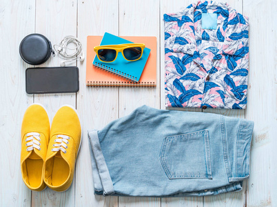 s casual outfits of traveler, summer holiday on wood background