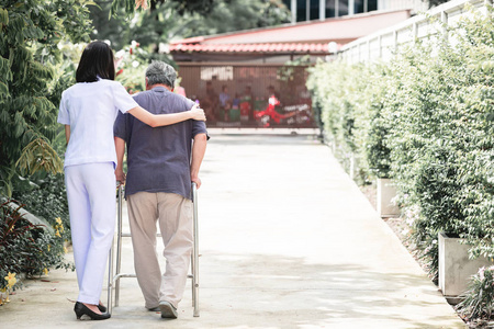 s shoulder in outdoor garden walking. Senior care, care taker an