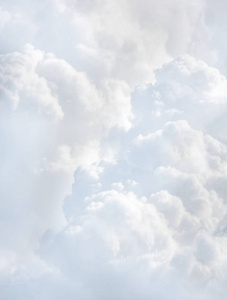 从云层上方的飞机上看到的天空。 抽象的自然背景与云的淡色调。 白色积云