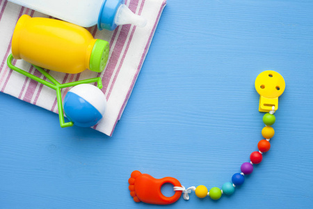 s shoes and toys on blue background. Newborn. Top view