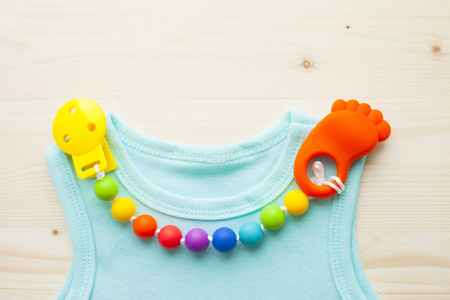 s shoes and toys on white wooden boards background. Newborn. Top