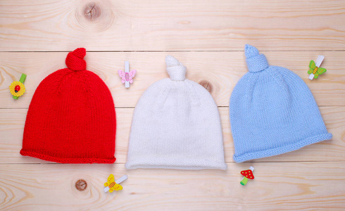 s knitted hats on a wooden background