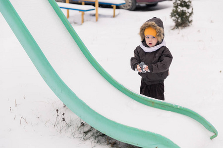 s slide and holding toy in hands