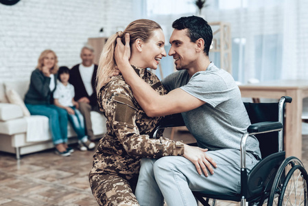 一个人从兵役中回来. 家庭会议. 从战争中离开. 拥抱家人. 伪装制服.