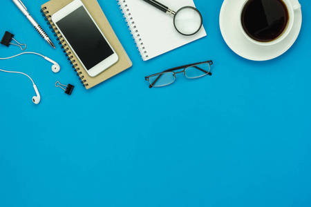  pen and coffee with earphone on modern rustic blue paper with c