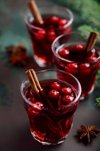 用蔓越莓覆盖红酒。 节日概念装饰冷杉枝和香料。