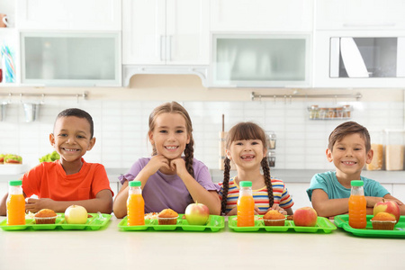孩子们在课间休息时坐在桌子上吃健康的食物