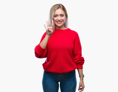 年轻的金发女人穿着冬天的毛衣，在孤立的背景上显示和手指第四，同时微笑自信和快乐。