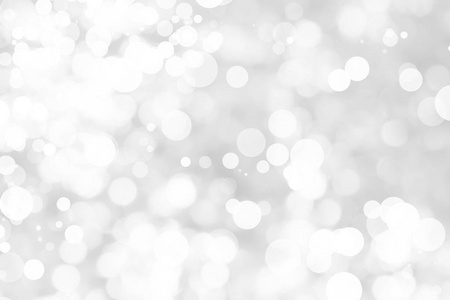 灰色背景上带有白色背景的抽象背景。 圣诞节模糊了美丽闪亮的圣诞灯。