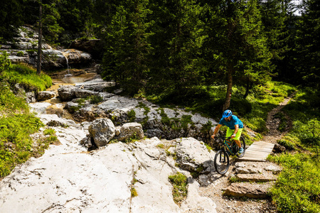 Ampezzo, stunning rocky mountains on the background. Man riding 