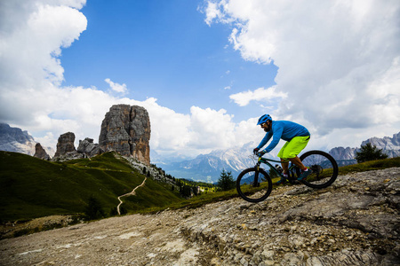 Ampezzo, stunning Cinque Torri and Tofana in background. Man rid