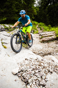 Ampezzo, stunning rocky mountains on the background. Man riding 