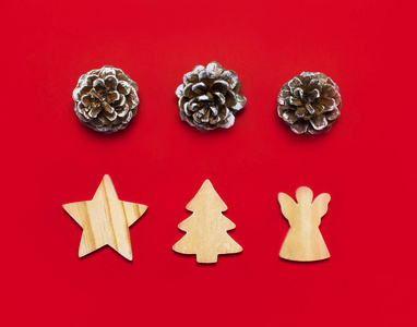 s wooden toys, fir cones on red background Flat lay top view cop