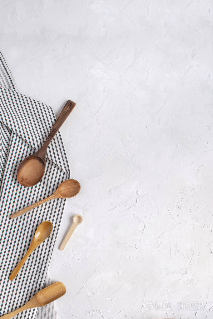 烹饪食物，最小的概念，木制勺子在皱巴巴的条纹餐巾纸。 顶部视图平躺复制空间。