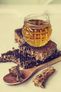 蜂蜜放在玻璃罐里，蜂蜜放在白色桌子上