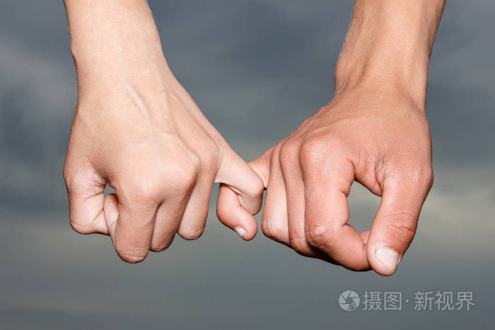 女性手在背景上握住男性的手.