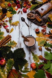 在木制背景下，用秋叶无花果和苹果制成的新鲜烤制的咖啡柱的顶部视图