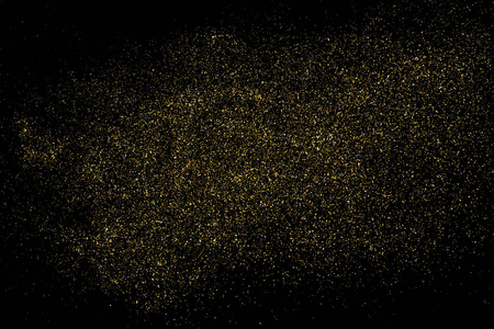 金色闪光的纹理隔离在黑色上. 琥珀颗粒的颜色. 庆祝背景.
