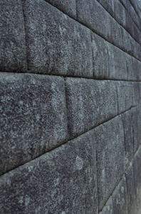 关闭一堵古老的印加文明墙在马丘皮丘库斯科秘鲁。 雕刻成完美装配的石头