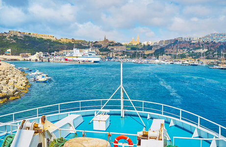 s deck on historic Mgarr harbour, full of yachts and boats, with