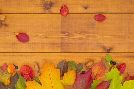 秋天的横幅，黄色的叶子在木制的纹理背景上。 感恩节的秋季背景