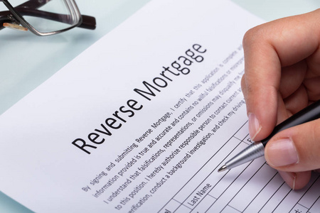 s Hand Filling Reverse Mortgage Form