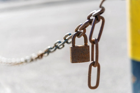 关闭生锈的链条与封闭的挂锁在一个模糊的背景