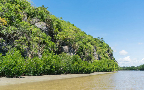 石头或岩石山或小山，有绿色的树，蓝天，水和云，在泰国的KhaoDang运河Khiri Khan泰国。 风景或风景夏季概念船游