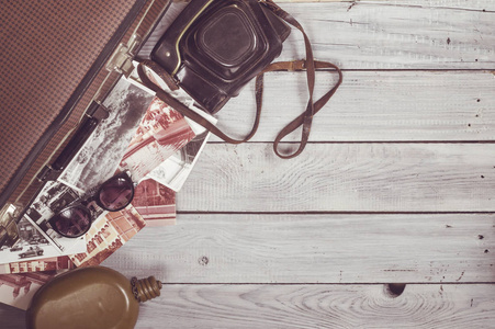 s hat and retro accessories for travel on a white painted wooden