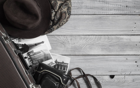 s hat and retro accessories for travel on a white painted wooden