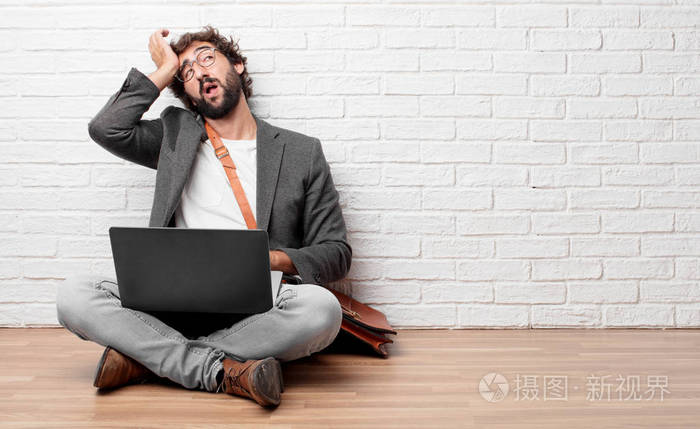 坐在地板上的年轻人看起来既不热情又无聊,听着一些枯燥乏味的东西