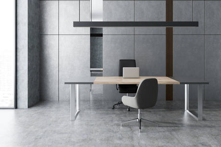 极简主义经理办公室内部有灰色的墙壁和地板阁楼窗口,大灰色和木制