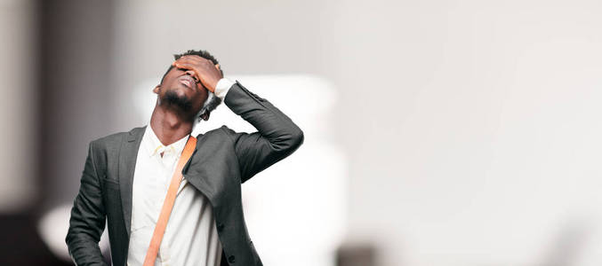 年轻的黑人商人带着失望和失败的悲伤表情,看上去沮丧绝望,痛苦不堪.