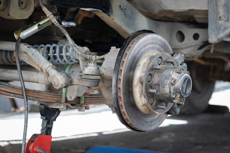 汽车的前轮被移除，以修复制动系统汽车工业和车库概念。