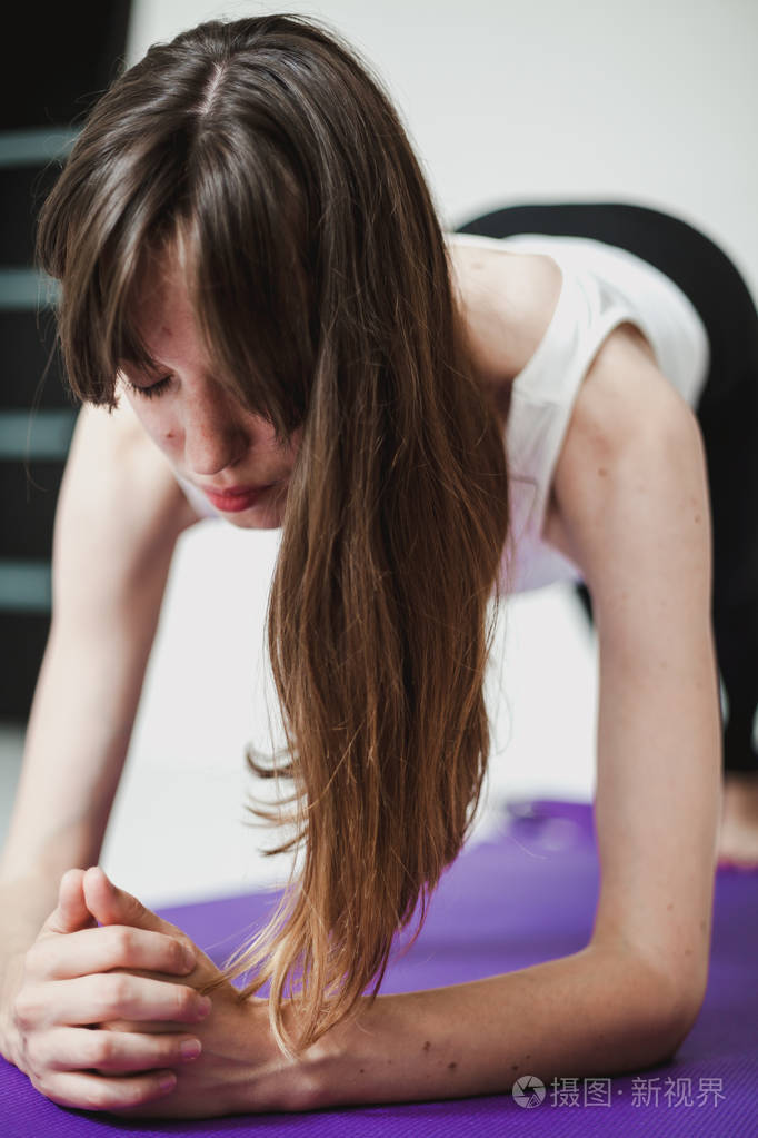 可爱的优雅女孩长发紧身衣在紫丁香的ru上做瑜伽