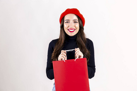  red beret, holding blank shopping bag. Autumn holiday sale seas