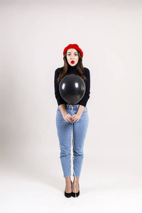  red beret, holding blank helium balloon. Holiday celebration co