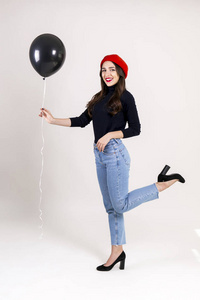  red beret, holding blank helium balloon. Holiday celebration co