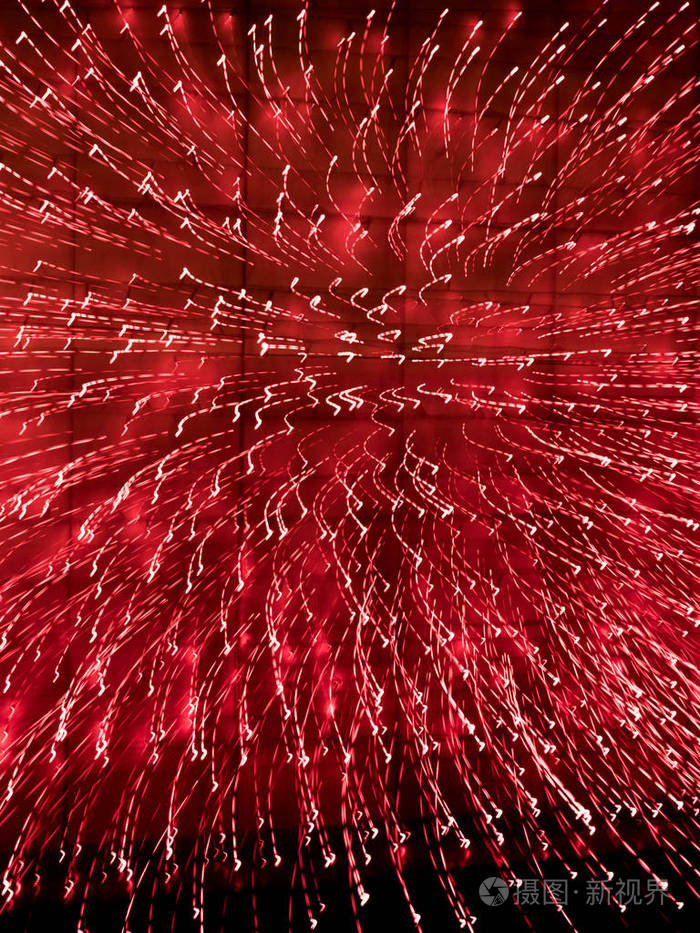 纹理从红线从明亮的夜晚火在黑暗的背景下旋转一个圆圈运动模糊